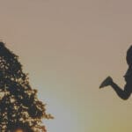 Man leaping over a canyon