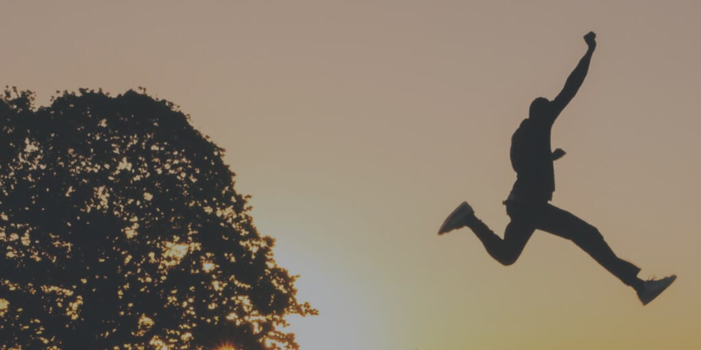 Man leaping over a canyon