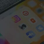 Photo of iPhone homescreen with social media apps; signaling executive visibility on social