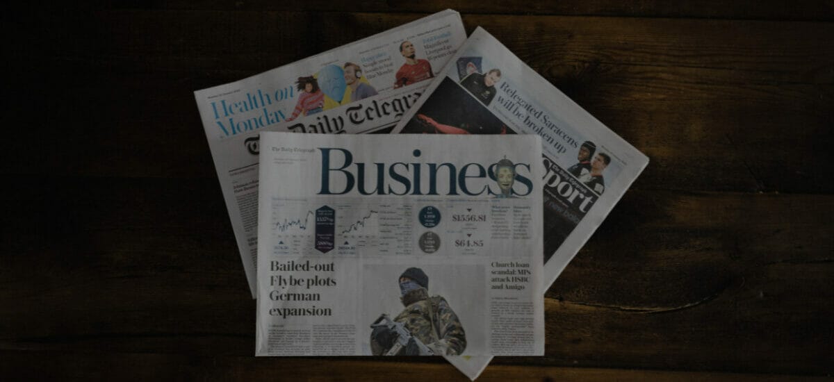 Three newspapers on a coffee table; signaling newsjacking.