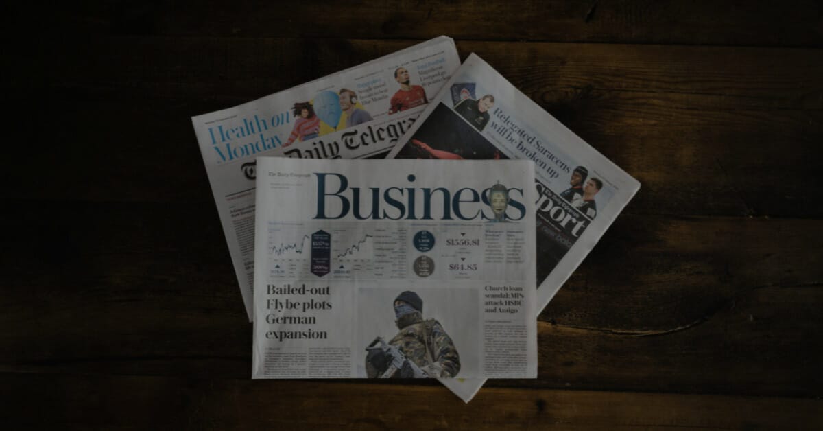 Three newspapers on a coffee table; signaling newsjacking.