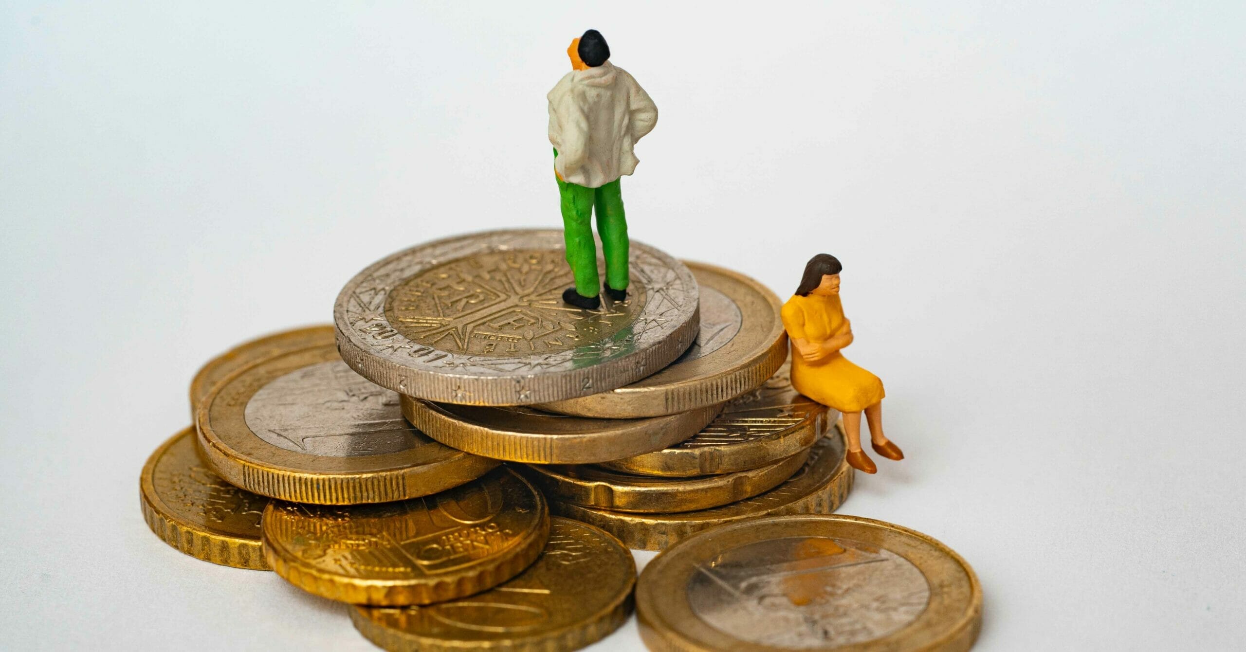 Man and woman sitting on unequal levels of coins