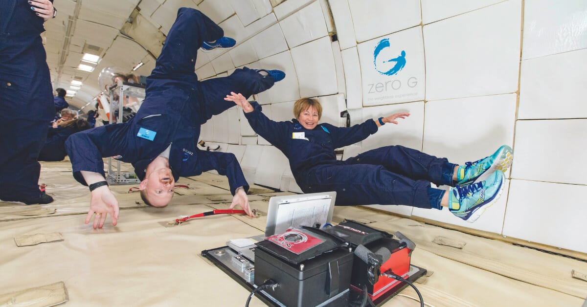 An image of two women doing experiments in a parabolic flight/Vomit Comet