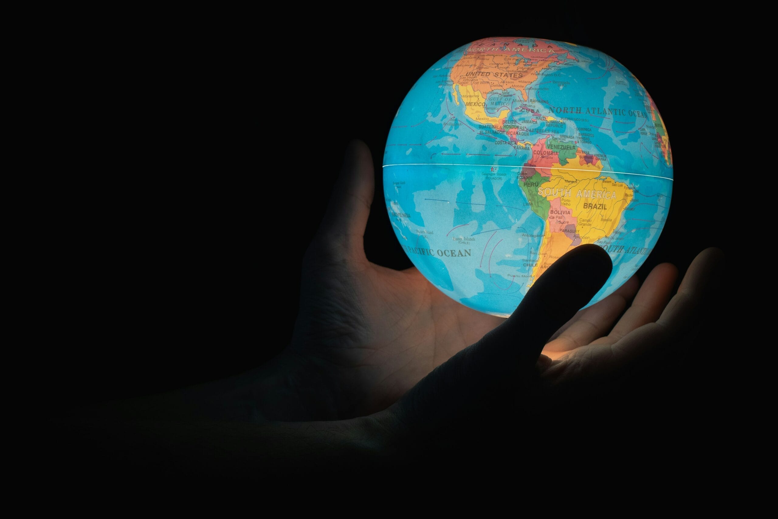 hands holding a light-up globe