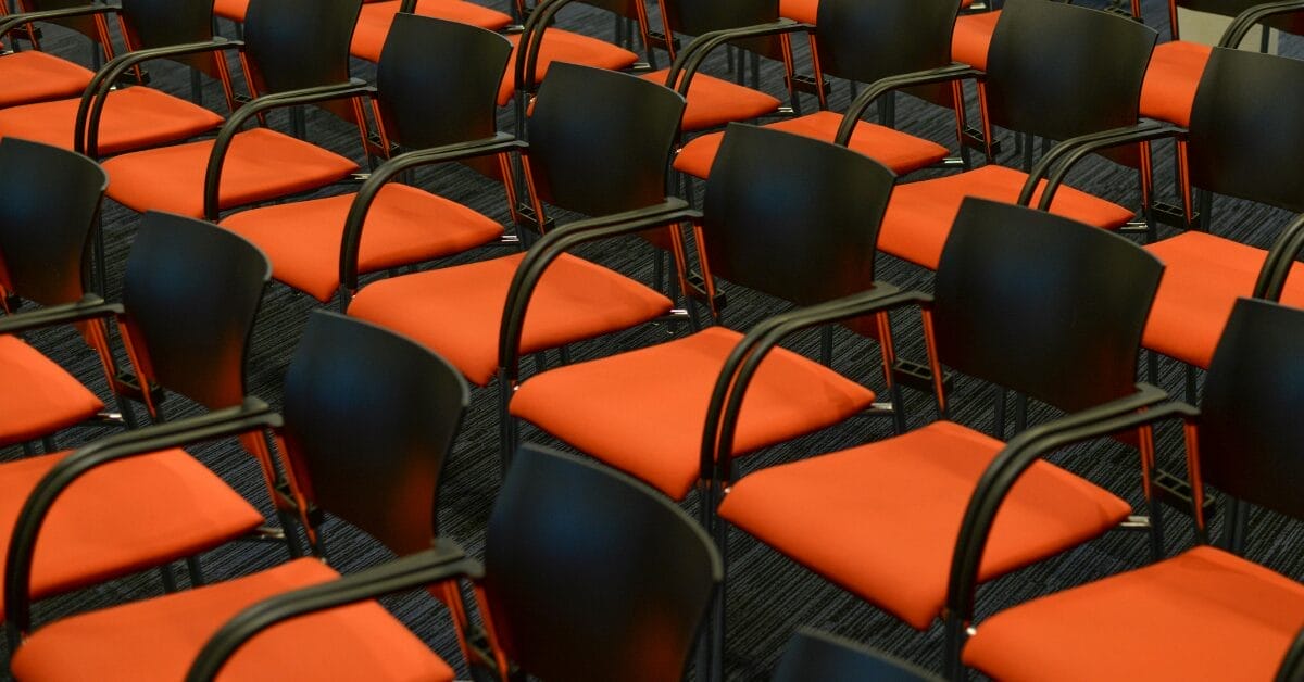 rows of black and orange conference chairs